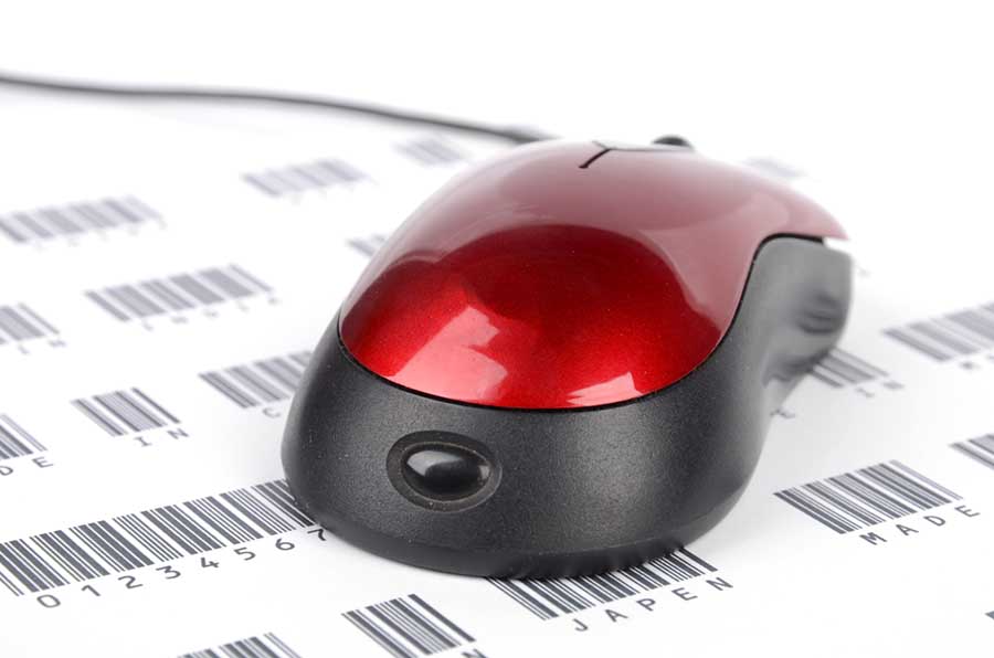 Red computer mouse sitting on top of printed barcodes